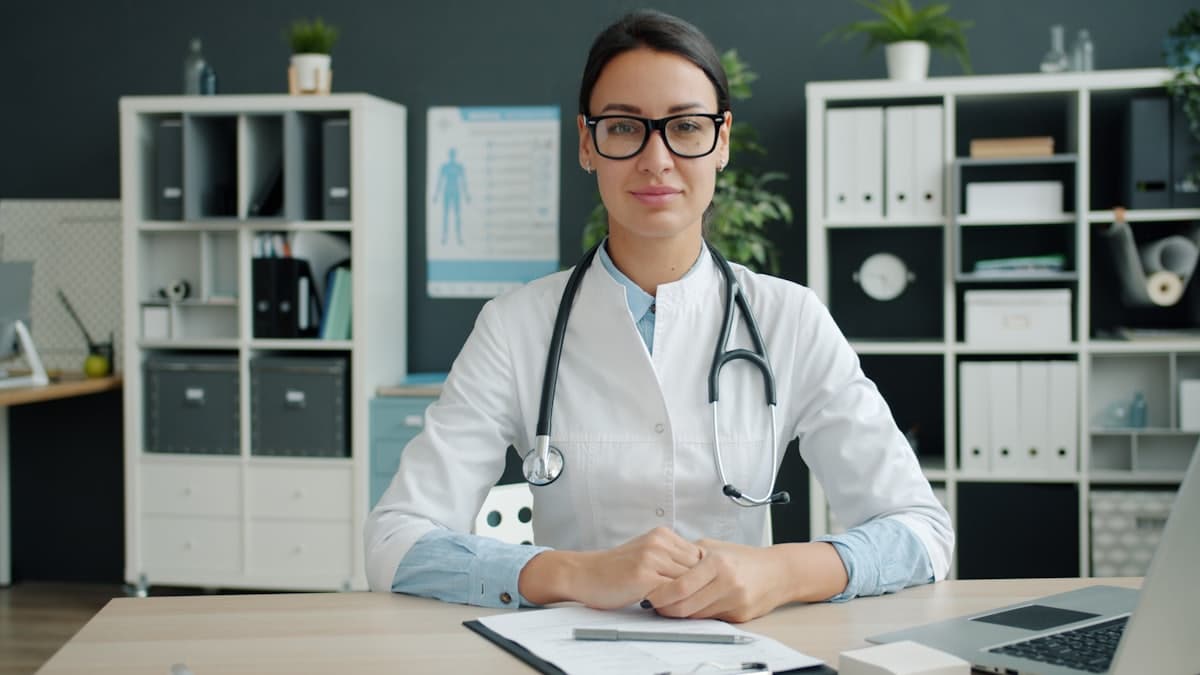 A doctor working at a consulting room desk