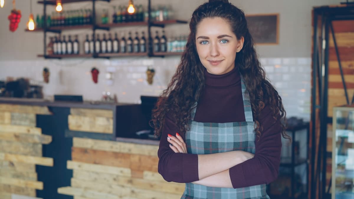 A shop owner standing behind the counter of her store