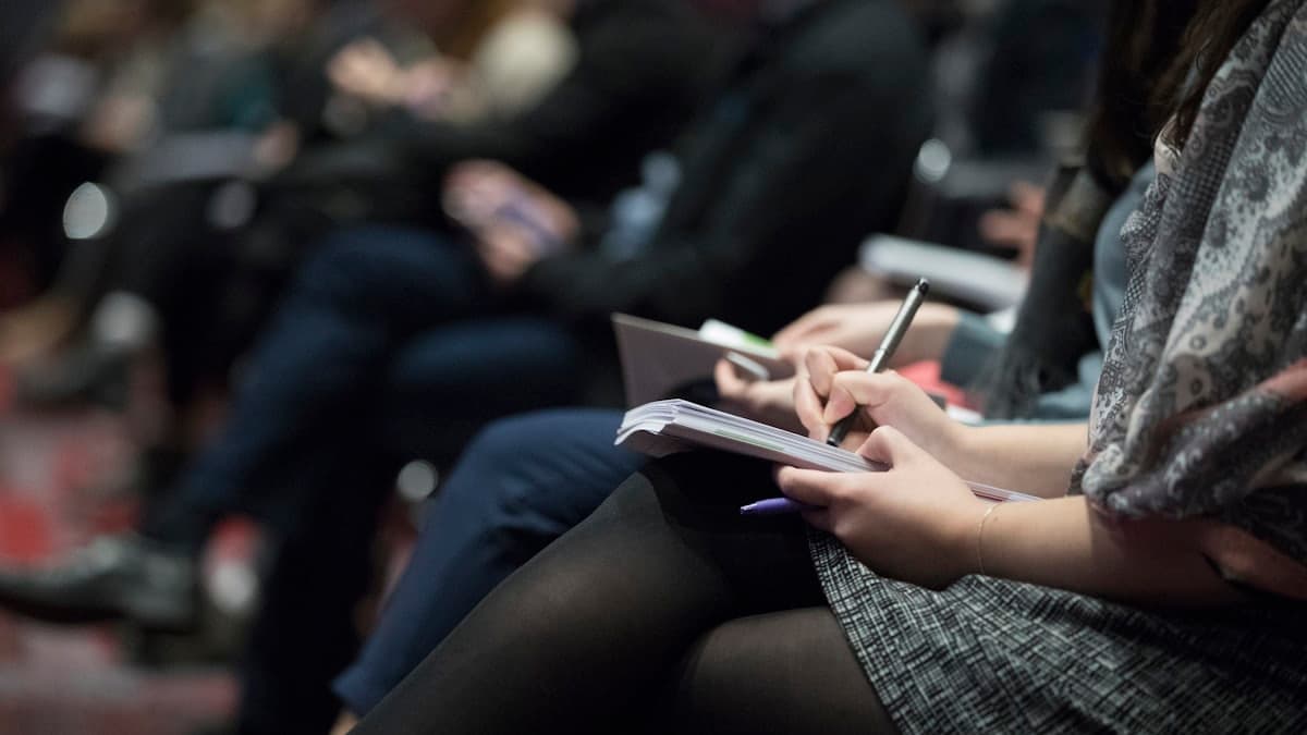 People taking notes during a training session